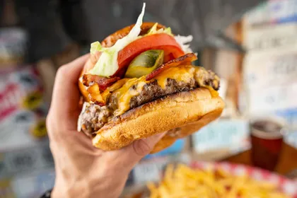 The Vandenburger cheeseburger with bacon, tomato and pickles