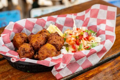 Killer Conch Fritters with cocktail sauce and slaw