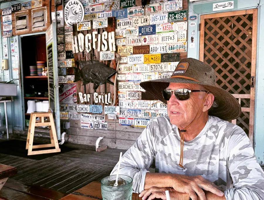 Jimmy Buffett sitting at his favorite table.