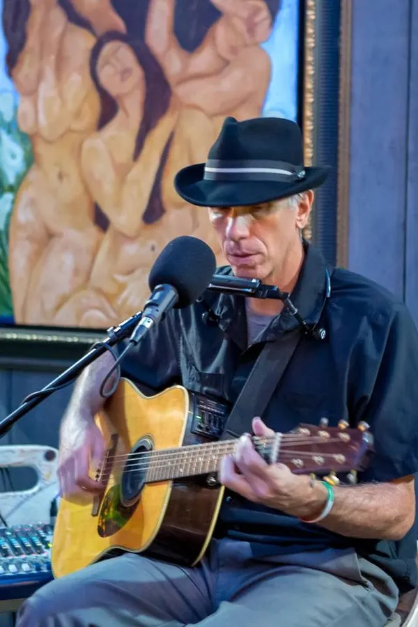 Lance Taylor playing acoustic guitar