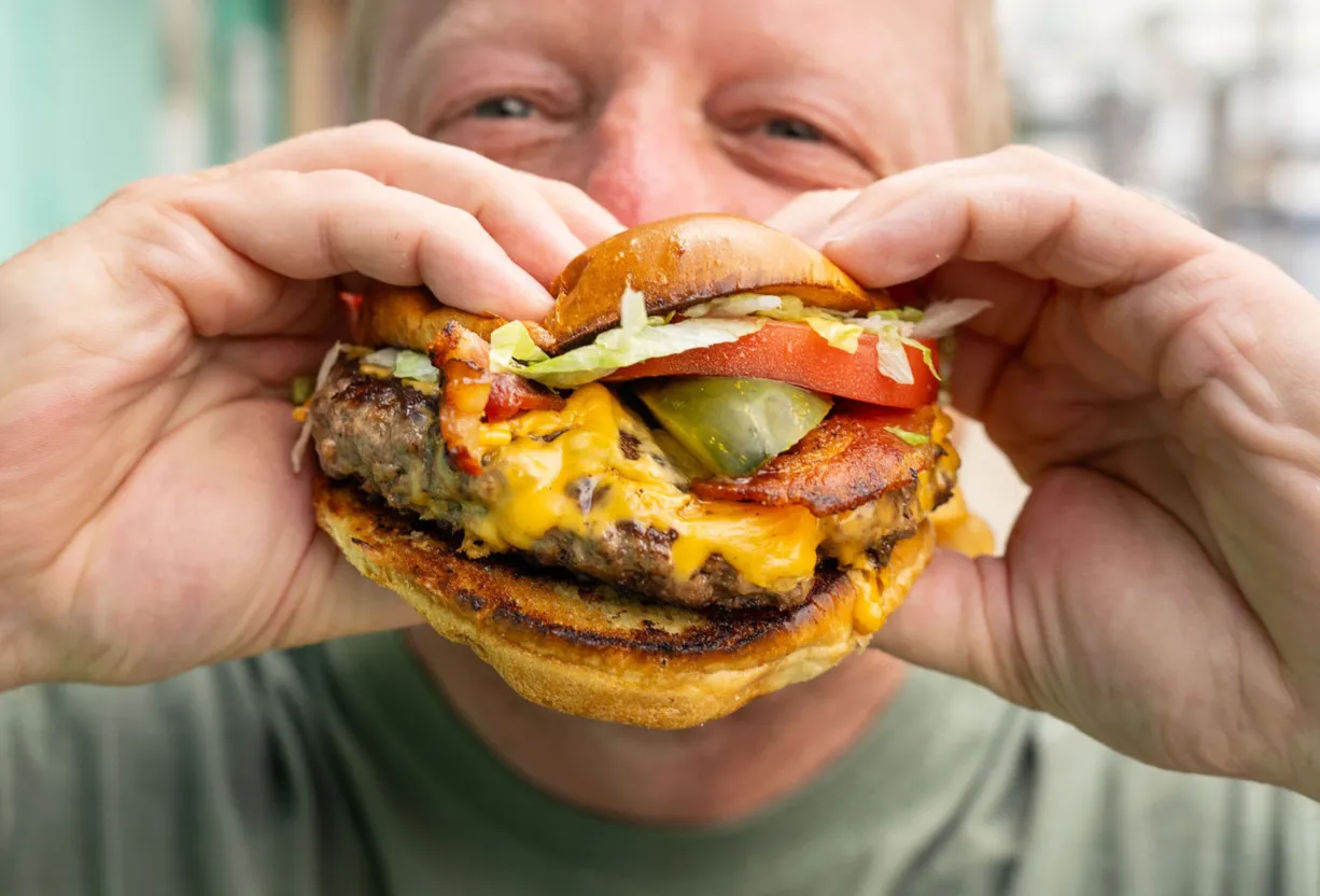 Man eating a cheeseburger