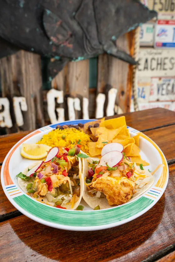 Our famous tacos, fish tacos with rice, black beans and chips